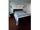 Comfortable bedroom with a wooden bed frame and striped bedding for a relaxing night's sleep at 184 Cedarcrest Dr, Acworth, GA 30101