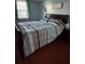 Comfortable bedroom with a wooden bed frame and striped bedding for a relaxing night's sleep at 184 Cedarcrest Dr, Acworth, GA 30101