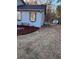 Detailed view of the backyard area showcasing mulched landscaping, siding, and wood shutters at 184 Cedarcrest Dr, Acworth, GA 30101