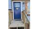 Close-up of a blue front door with a decorative wreath, framed by a white trim and a charming porch setting at 184 Cedarcrest Dr, Acworth, GA 30101
