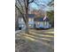 Inviting two-story home with blue exterior, complemented by mulched landscaping, a bench, and an American flag at 184 Cedarcrest Dr, Acworth, GA 30101