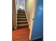 Hallway featuring wood floors, a carpeted staircase, and a doorway leading to another room at 184 Cedarcrest Dr, Acworth, GA 30101