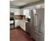 A bright kitchen with stainless steel appliances, granite countertops, tiled backsplash and white cabinets at 184 Cedarcrest Dr, Acworth, GA 30101