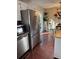 Open kitchen layout with stainless steel refrigerator, tile backsplash, and adjacent dining area at 184 Cedarcrest Dr, Acworth, GA 30101