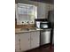 A kitchen sink area with granite countertops, white cabinets, window view, stainless steel appliances at 184 Cedarcrest Dr, Acworth, GA 30101