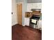 Functional kitchen with stainless steel appliances, pantry door and warm wood-look flooring at 184 Cedarcrest Dr, Acworth, GA 30101