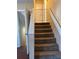 A carpeted staircase leading to the upper level, featuring a safety gate at the top at 184 Cedarcrest Dr, Acworth, GA 30101