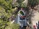 Aerial view of a charming home featuring a backyard pool, deck, mature trees, and an expansive driveway at 98 Pace Dr, Hiram, GA 30141