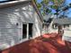 View of the back of the house with an attached deck and sliding glass door at 98 Pace Dr, Hiram, GA 30141