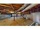 Unfinished basement features concrete flooring and cinder block walls with exposed wood ceiling rafters and duct work at 98 Pace Dr, Hiram, GA 30141