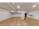 Finished basement with wood-look flooring, white painted walls, and recessed lighting at 98 Pace Dr, Hiram, GA 30141