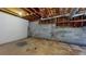 Unfinished basement features concrete flooring and cinder block walls with exposed wood ceiling rafters at 98 Pace Dr, Hiram, GA 30141
