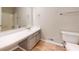 Neutral bathroom features a long vanity, large mirror, and marble-look flooring at 98 Pace Dr, Hiram, GA 30141