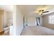 Bedroom and ensuite bathroom featuring carpet, neutral walls, and a ceiling fan at 98 Pace Dr, Hiram, GA 30141