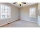 Neutral bedroom with carpet, two windows, ceiling fan, and baseboard trim at 98 Pace Dr, Hiram, GA 30141