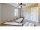 Bright bedroom with ceiling fan, neutral walls, carpet floors, and a window for natural light at 98 Pace Dr, Hiram, GA 30141