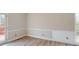 Bright dining room with wainscoting, wood flooring, and glass doors leading to an outdoor deck at 98 Pace Dr, Hiram, GA 30141