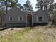Charming exterior view of the home with gray siding, shutters, and manicured front yard at 98 Pace Dr, Hiram, GA 30141
