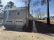 Spacious two-car garage connected to the home with a level driveway and landscaping, perfect for convenience at 98 Pace Dr, Hiram, GA 30141
