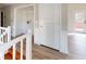 Hallway featuring wood floors, white trim, and access to different areas at 98 Pace Dr, Hiram, GA 30141