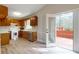 Traditional kitchen featuring wooden cabinets, white appliances, and access to the outdoor deck at 98 Pace Dr, Hiram, GA 30141