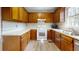Traditional kitchen with wooden cabinets, white appliances, and a window over the sink at 98 Pace Dr, Hiram, GA 30141