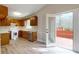 Kitchen featuring wooden cabinets, white appliances, and access to an outdoor deck at 98 Pace Dr, Hiram, GA 30141
