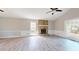 Bright living room features beautiful stone fireplace, ceiling fan, neutral paint and gorgeous wood-look laminate flooring at 98 Pace Dr, Hiram, GA 30141