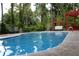 Outdoor pool with poolside seating and lush greenery for a private retreat at 98 Pace Dr, Hiram, GA 30141