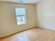 Bright bedroom featuring hardwood floors and a window providing natural light at 1604 Hampton Hollow Trl, Lawrenceville, GA 30043