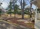 Expansive backyard with mature trees, offering privacy and natural beauty next to a porch at 1619 Flowery Branch Rd, Auburn, GA 30011