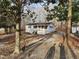 Charming home with a covered porch and well-maintained exterior nestled amongst mature trees at 1619 Flowery Branch Rd, Auburn, GA 30011