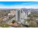 Aerial view of a high rise luxury apartment building, pool, surrounding neighborhood, and city skyline at 2520 Peachtree Nw Rd # 403, Atlanta, GA 30305