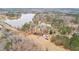 Aerial view of wooded land with the house, driveway, and lakes in the background at 260 Sandy Lake Cir, Fayetteville, GA 30214