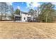 View of the back of this charming house featuring a screened-in porch and a large deck at 260 Sandy Lake Cir, Fayetteville, GA 30214