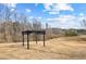 View of the black pergola on the expansive lawn of this beautiful property with lovely, wooded views at 260 Sandy Lake Cir, Fayetteville, GA 30214