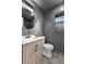 Modern bathroom featuring a round mirror, updated vanity, and dark accent wall at 260 Sandy Lake Cir, Fayetteville, GA 30214