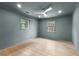 Cozy bedroom with wood-look floors, a ceiling fan, and multiple windows for ample natural light at 260 Sandy Lake Cir, Fayetteville, GA 30214