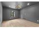 Bedroom with stylish light fixture, light wood floors, and neutral colored walls at 260 Sandy Lake Cir, Fayetteville, GA 30214