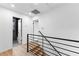 Upstairs hallway with new wood flooring and black metal railings at 260 Sandy Lake Cir, Fayetteville, GA 30214