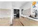 Bright kitchen area with modern cabinets, sink, backsplash, and a view to the laundry area at 260 Sandy Lake Cir, Fayetteville, GA 30214