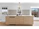 A spacious kitchen island features modern wood cabinets, a white countertop, and a sleek black faucet at 260 Sandy Lake Cir, Fayetteville, GA 30214
