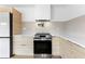 Modern kitchen with stainless steel appliances, wooden cabinets, tile backsplash, and contemporary range hood at 260 Sandy Lake Cir, Fayetteville, GA 30214
