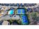 An aerial view of a neighborhood swimming pool and tennis courts at 3540 Paddocks Pkwy, Suwanee, GA 30024