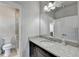 Bathroom vanity with granite counters, black cabinets, decorative mirror and adjacent shower at 3540 Paddocks Pkwy, Suwanee, GA 30024