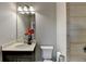 Bathroom featuring a vanity, toilet, shower, and decorative mirror at 3540 Paddocks Pkwy, Suwanee, GA 30024