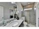 Modern bathroom featuring sleek glass shower, stone countertops and decorative orchid at 3540 Paddocks Pkwy, Suwanee, GA 30024