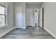 Modern bedroom features gray wood flooring, natural light and access to other rooms through bright white doors at 3540 Paddocks Pkwy, Suwanee, GA 30024