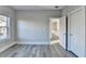 Gray wood-look floor bedroom with a double door closet and a window at 3540 Paddocks Pkwy, Suwanee, GA 30024