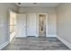 View of interior doors and gray wood-look floors in a bedroom at 3540 Paddocks Pkwy, Suwanee, GA 30024